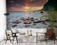 Surf foams over stones on this coastal sunset serenity wall mural sample.