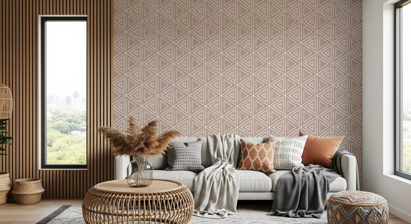 Earthy and mottled, the dusty rose ground warms the boho geometric wallpaper.