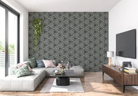Sketched cream triangles run across a charcoal mudcloth wallpaper in a chic living room.