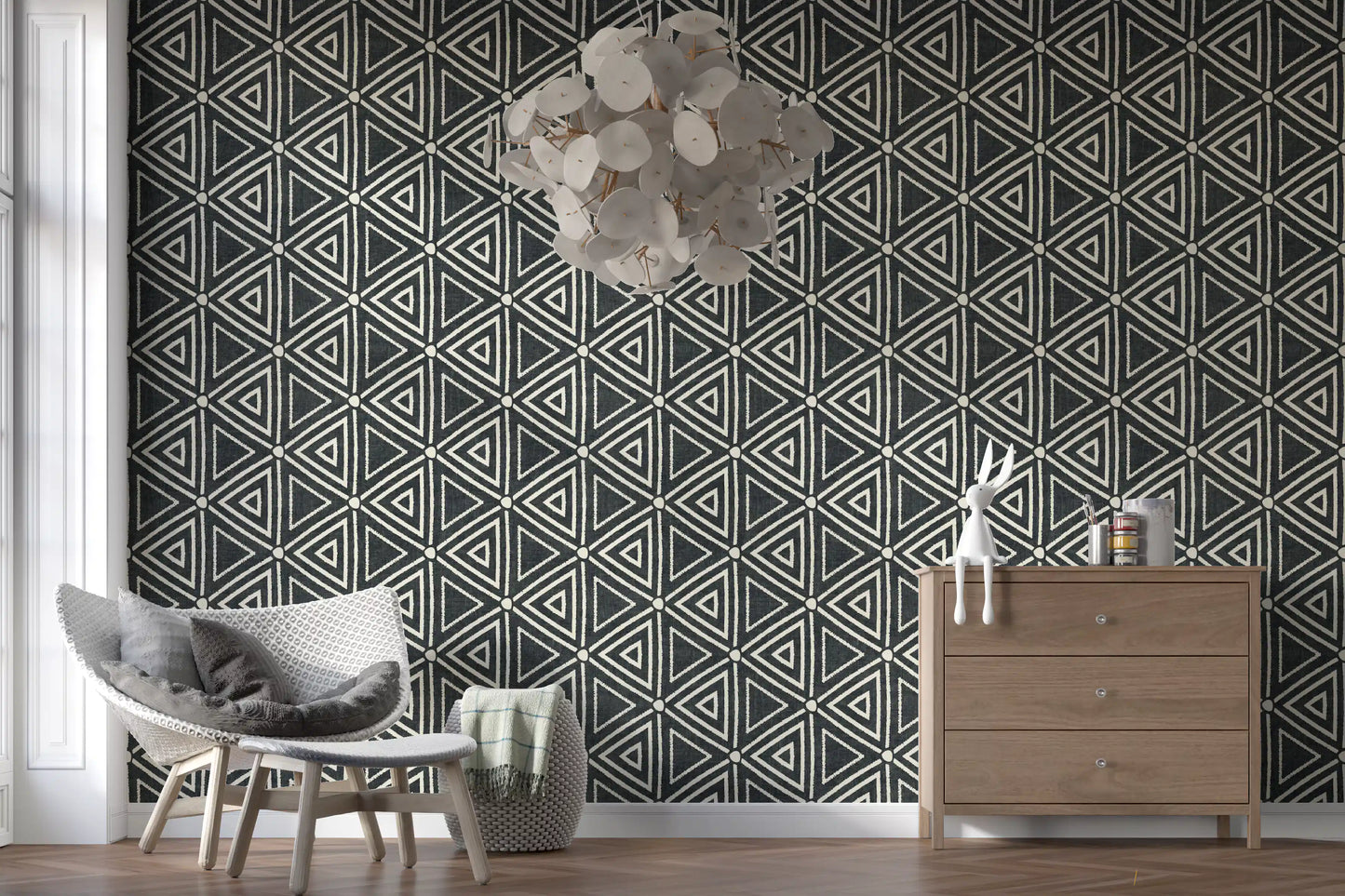Charcoal Boho wallpaper fits into a bright open living room with triangle motifs.