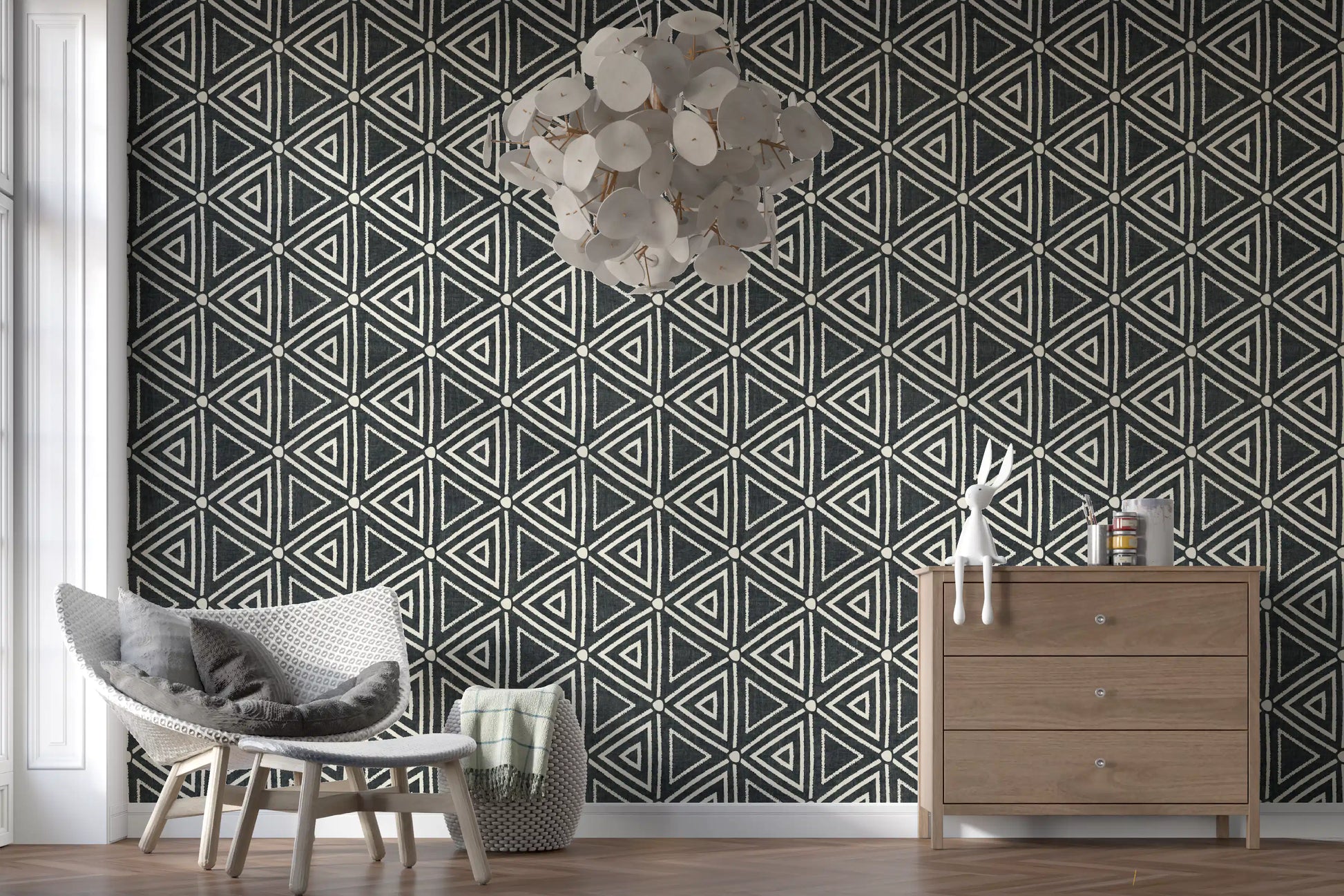 Charcoal Boho wallpaper fits into a bright open living room with triangle motifs.