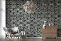 Charcoal Boho wallpaper fits into a bright open living room with triangle motifs.
