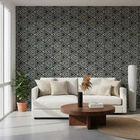 Charcoal mudcloth wallpaper grounds a cosy living room with bold cream triangle pattern.
