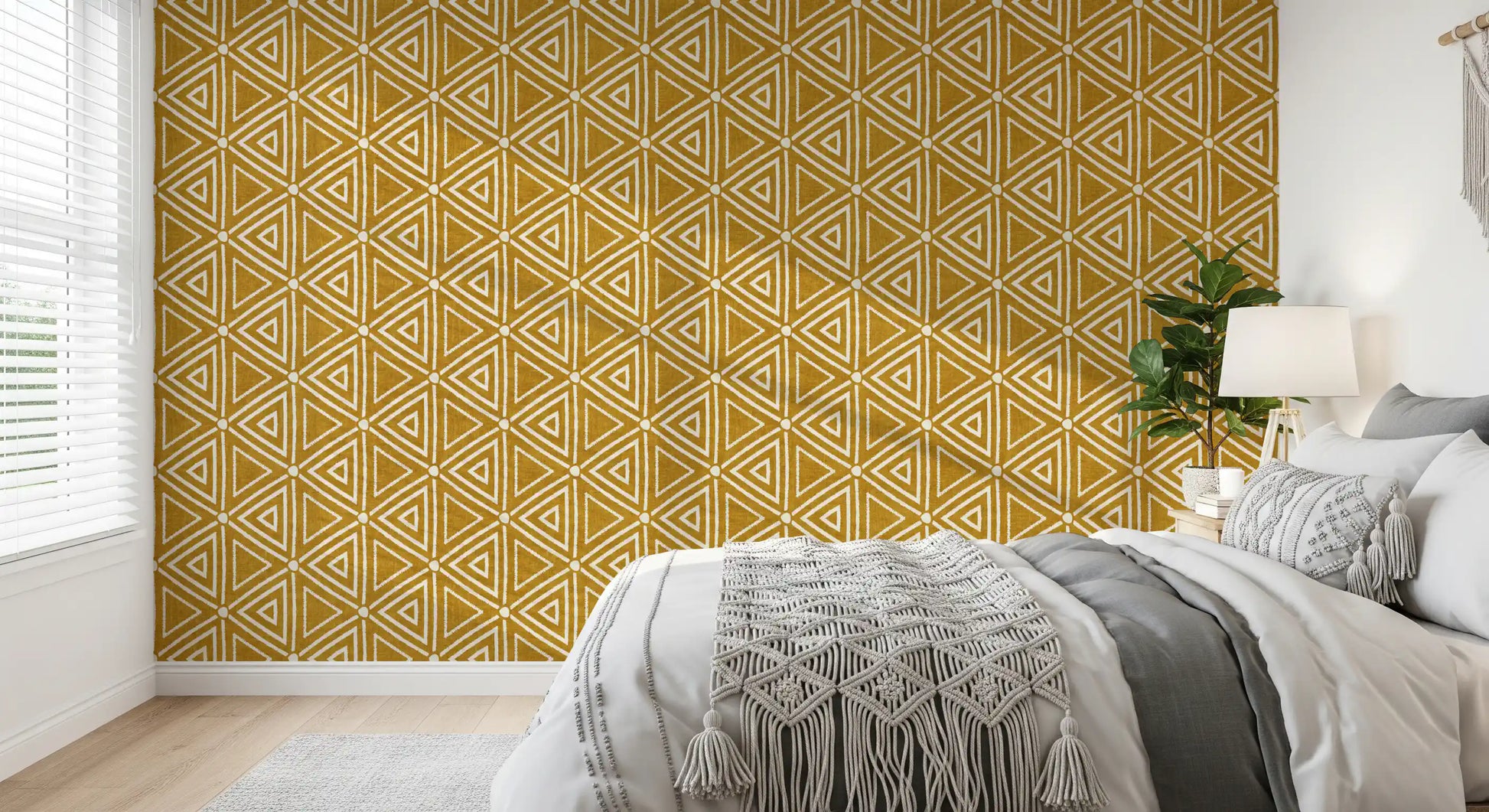 Bold white triangles repeat across this mustard yellow mudcloth wallpaper.