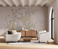 Sitting room scaled around a painterly wall mural of vines and songbirds.