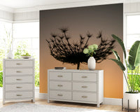 Beside a hallway corner, this sunset silhouette wall mural casts a warm gold glow.