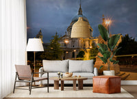 Warm-lit cathedral wall mural mounted on a living room under storm clouds