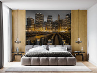 Night city wall mural above a Bedroom area with gold and monochrome tones