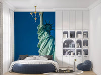 Vivid blue sky and copper-green liberty wall mural composition