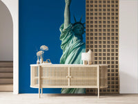 Liberty's Azure Grace wall mural with torch raised against blue sky