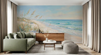 Painterly shoreline mural showing dune grasses and gentle ocean surf.