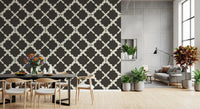 Deep charcoal brown lattice trellis geometric wallpaper with cream curved pattern on textured background.