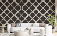Dark brown trellis geometric wallpaper on living room accent wall with cream lattice detail