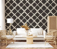 Large-scale repeating curved lattice motif in dark charcoal on textured wallpaper.