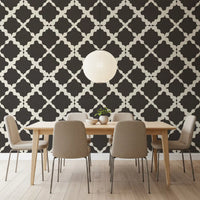 Charcoal lattice trellis pattern wallpaper as a feature wall in a dining room setting 