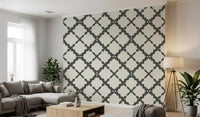Geometric lattice wallpaper with dark grey curved trellis on cream background. 
