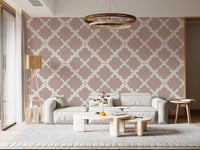 Geometric dusty rose trellis wallpaper installed as a feature wall in a living room.