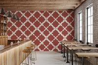 Large-scale curved trellis repeat wallpaper in bold rust red and cream background. 