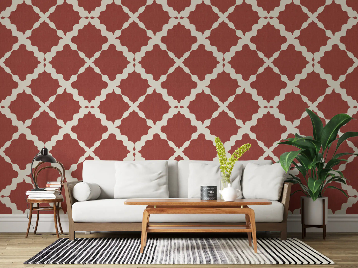 Geometric trellis wallpaper on a living room wall in rust red and cream.