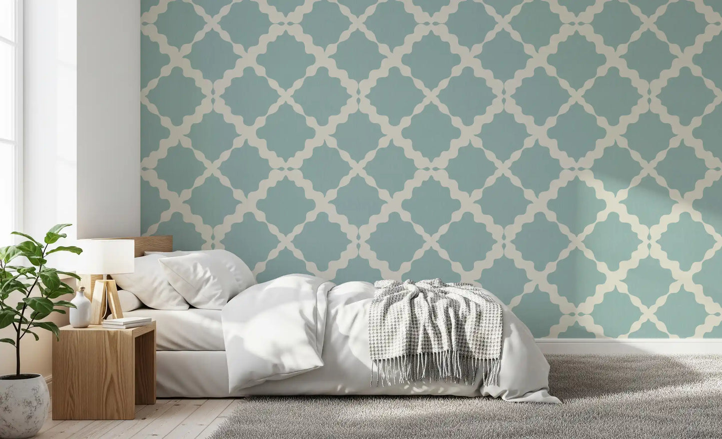 Dusty teal lattice pattern wallpaper as a feature wall in a bedroom setting.