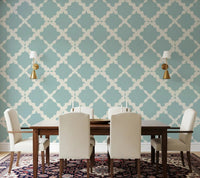 Muted blue trellis geometric wallpaper on dining room accent wall with cream lattice detail.