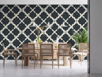 Minimalist charcoal and cream trellis repeat pattern wallpaper in dining area.