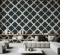 Living room accent wall with charcoal trellis lattice geometric wallpaper.