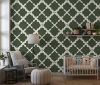 Bold trellis wallpaper in deep moss green and cream with interlocking flowing geometric curves.