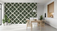 Bold trellis geometric wallpaper in deep green applied to a dining room wall