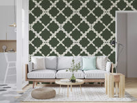 Moss green geometric trellis lattice wallpaper with cream-colored curved lines on a linen-textured surface.
