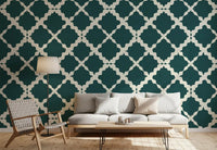 Living room accent wall with deep teal geometric lattice trellis wallpaper. 