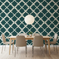 Dining room feature wall with cream and teal trellis geometric wallpaper.