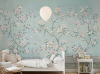 Serene chinoiserie mural on bedroom feature wall with birds and blooming peonies.
