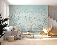 Blue, green, and yellow birds perched on flowering branches in chinoiserie aviary wall mural.