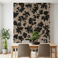 Black painterly floral shapes on beige distressed surface wall mural.
