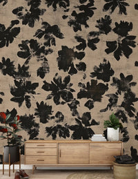 Hallway wall covered in distressed black floral silhouette mural with beige ground.