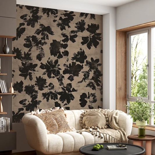 Living room wall covered with distressed black floral silhouette mural in beige. 