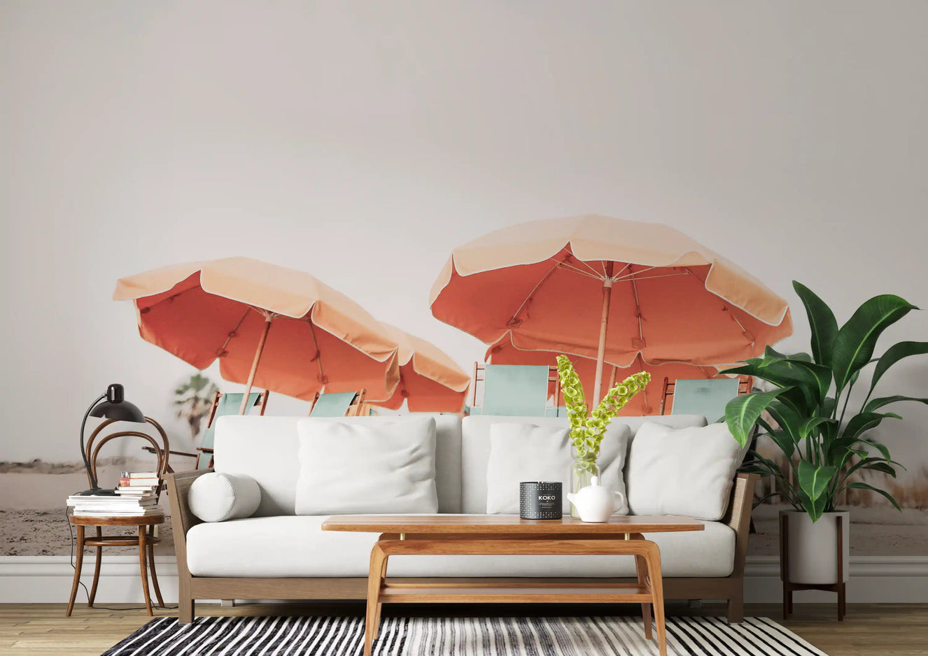 Living room beach mural with coral umbrellas and seafoam tones on sandy shore. 