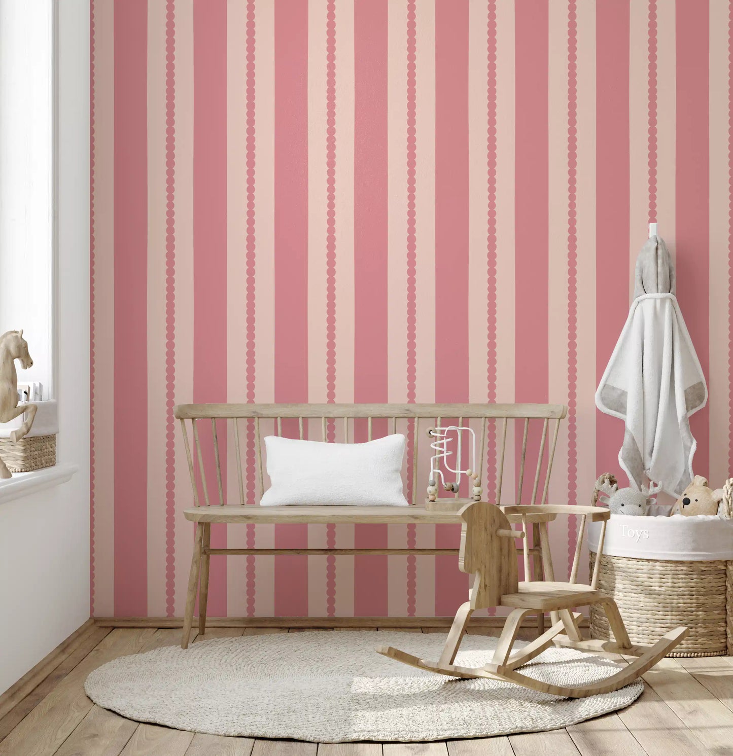Two-tone stripe wallpaper with circular scallop trim in muted pink shades.