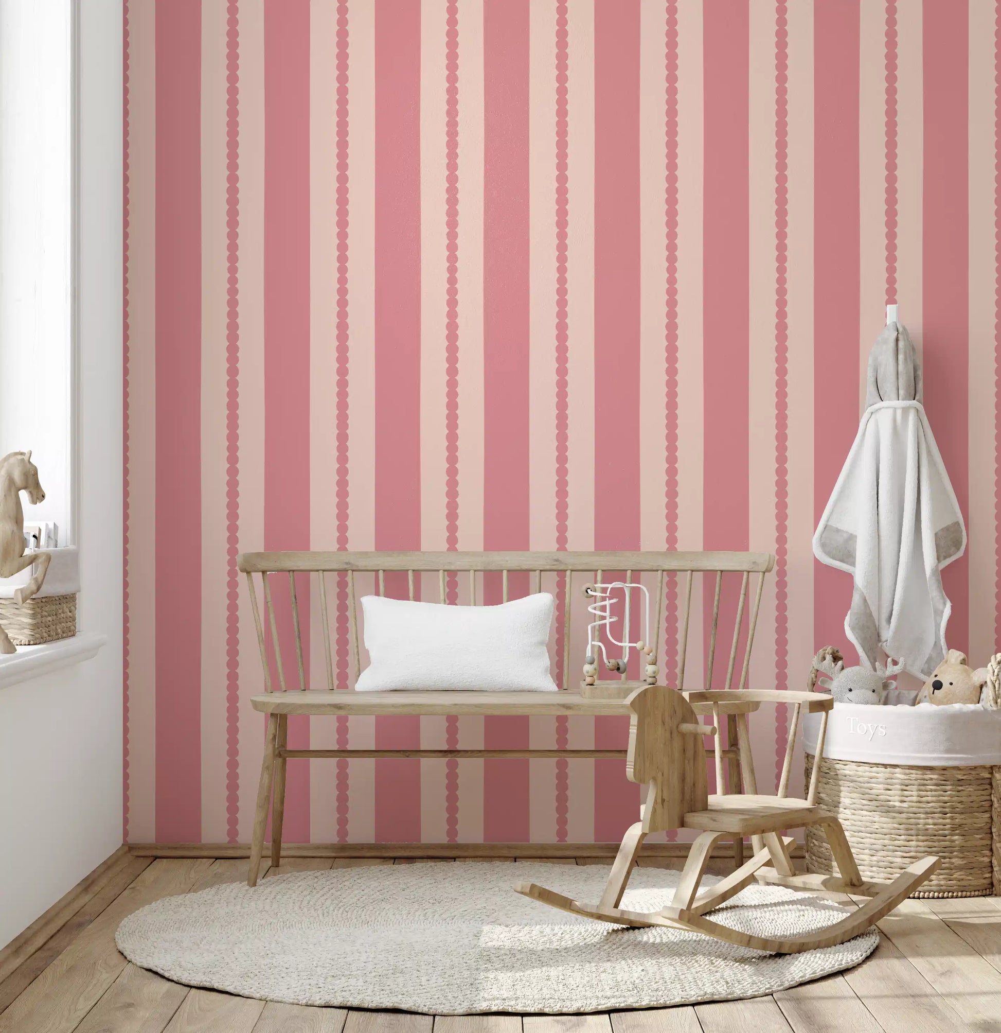 Two-tone stripe wallpaper with circular scallop trim in muted pink shades.