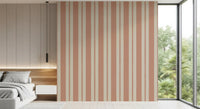Repeating terracotta and sand vertical stripe wallpaper in bright bedroom.