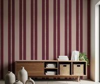 Hallway wall with scallop stripe wallpaper in blush and berry.
