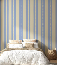 Scalloped stripe blue and cream wallpaper on a bedroom accent wall. 