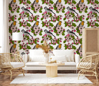 Birds and blossoms repeat pattern wallpaper with pink flowers on white.