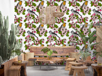 Floral bird repeat pattern with buds and blossoms on white wallpaper.