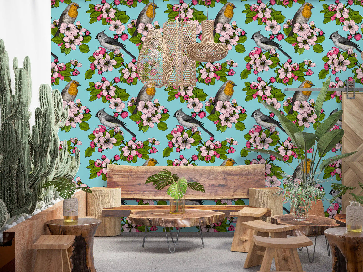 Blue base birds and blossoms wallpaper pattern showing layered pink petals and green foliage.