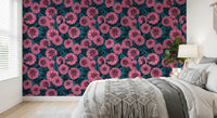 Botanical leaf pattern with pink garden flowers on black wallpaper.