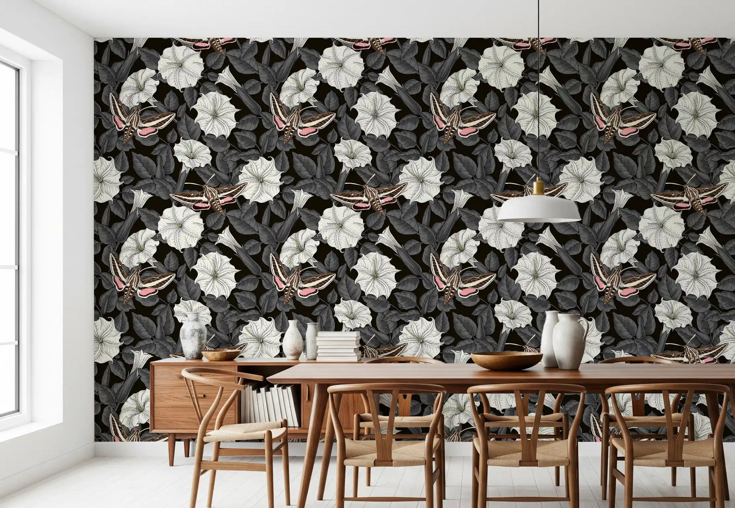 Dark botanical wallpaper featuring white trumpeted flowers and moths.