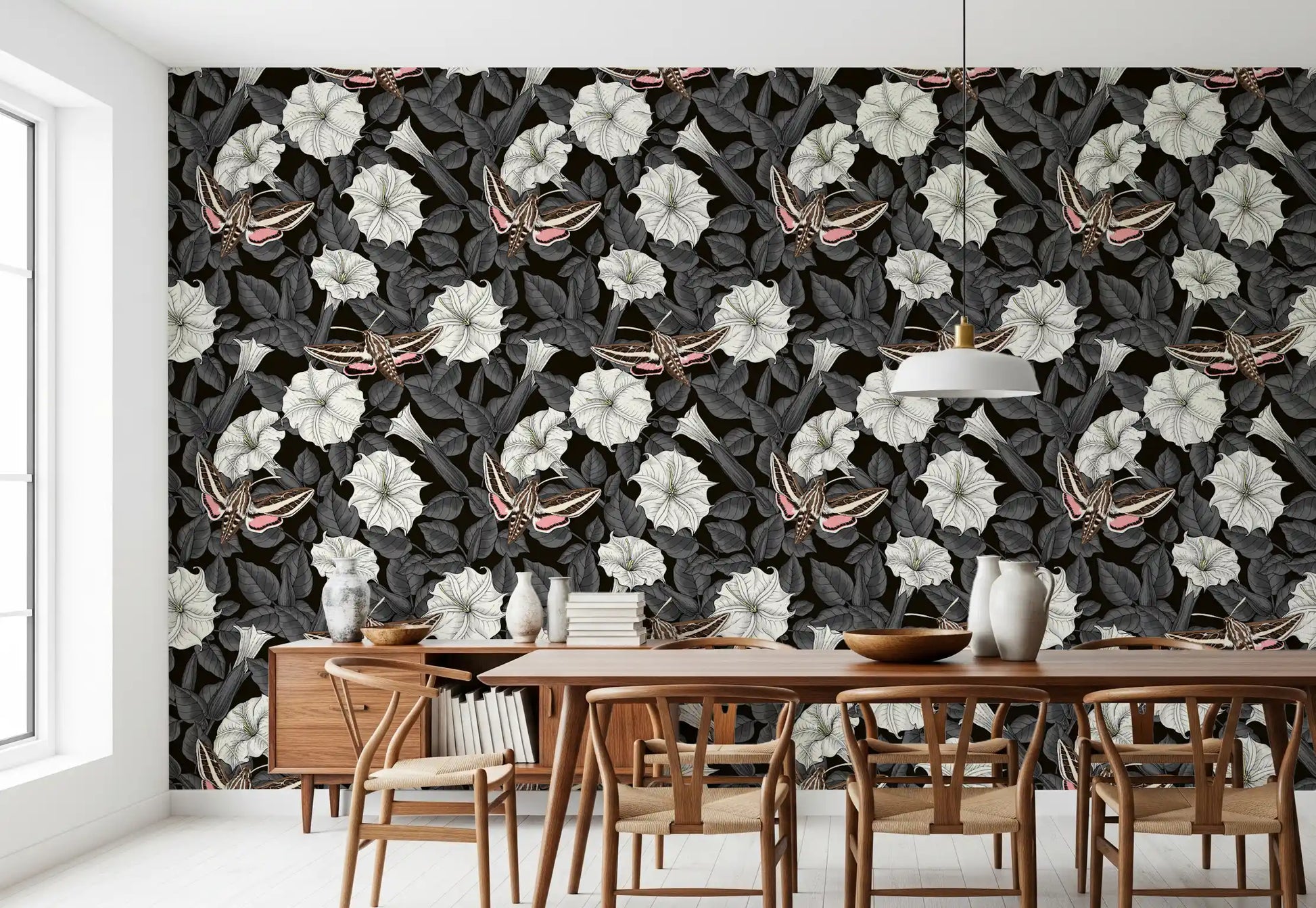 Dark botanical wallpaper featuring white trumpeted flowers and moths.