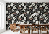 Dark botanical wallpaper featuring white trumpeted flowers and moths.
